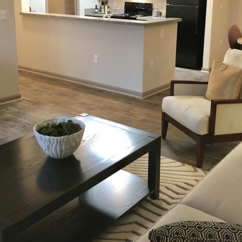 Relax and unwind in stylish living spaces furnished living room next to kitchen